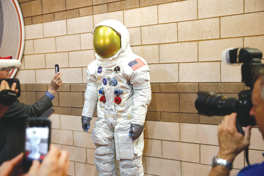 Visitors photograph a statue of Neil Armstrong's Apollo 11 spacesuit before an interleague baseball game between the Chicago White Sox and the Washington Nationals, Tuesday, June 4, 2019, in Washington.