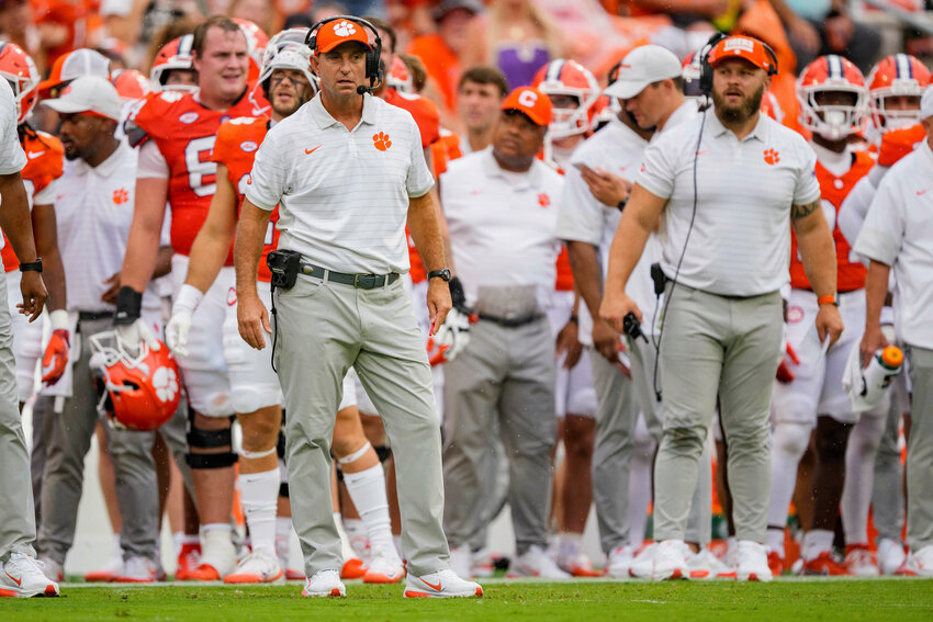 Clemson head coach Dabo Swinney, left, and the Tigers face North Carolina, coached by NFL legend Bill Belichick, on Saturday.