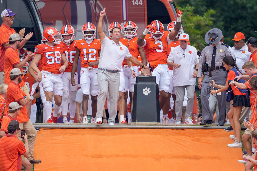 Clemson head coach Dabo Swinney, center, touches Howard's Rock prior to the Tigers' game against Troy on Saturday, Sept. 6, in Clemson.