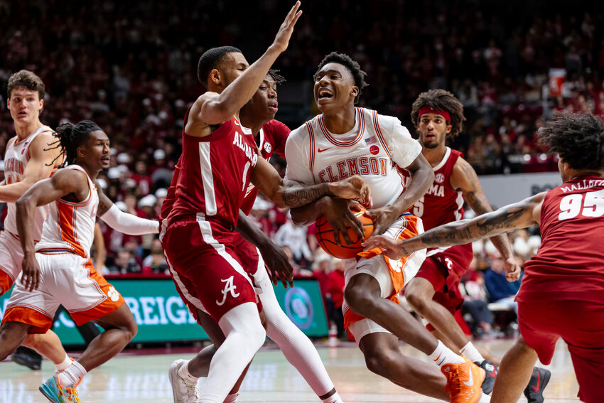 Clemson guard Zac Foster (5) drives into coverage by Alabama guard Davion Hannah (4) on Wednesday, Dec. 3, 2025, in Tuscaloosa, Alabama.