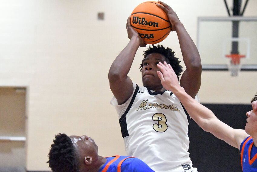 Manning's Lovon Stevenson, seen facing Laurence Manning during the District 9 Officials Christmas Basketball Tournament, had a 28-point, 12-rebound double-double in the Monarchs' win over Lake City on Friday.