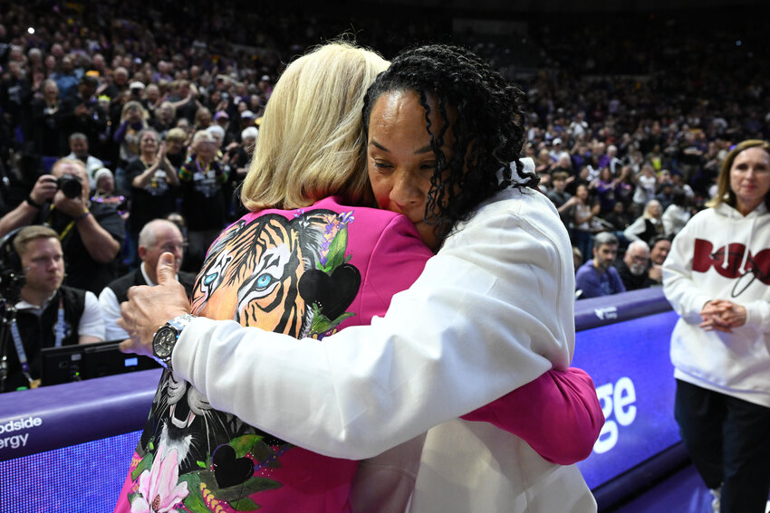 LSU head coach Kim Mulkey, left, and South Carolina head coach Dawn Staley share a pregame embrace in Baton Rouge on Saturday, Feb. 14, 2026.