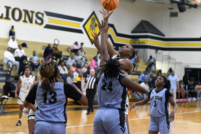 Lee Central's My'Keriyah Holmes, center back, shoots against Hunter-Kinard-Tyler during their matchup in the third round of the SCHSL 1A playoffs on Monday.