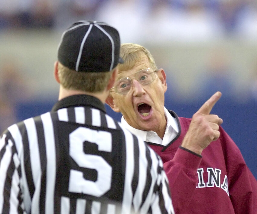 Former South Carolina coach Lou Holtz, seen right sharing words with side judge Randy Jackson during the first half against Kentucky on Saturday, Oct. 12, 2002, in Lexington, Kentucky, passed away on Wednesday at the age of 89.
