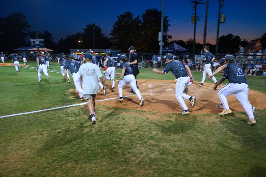The East Clarendon baseball team rushes the field after a walk-off win over Cheraw on Monday in the SCHSL 2A lower state semifinals.