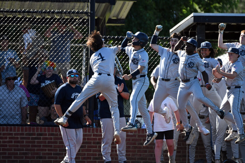 The East Clarendon baseball team celebrates with Kenley Sullivan (4) after the catcher's solo home run to lead off the game against Atlantic Collegiate on Wednesday in the SCHSL 2A lower state championship game.