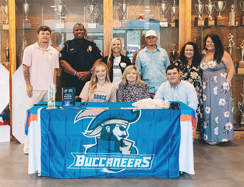 Laurence Manning senior Brynley Weatherly, seated left, is surrounded by friends and family after signing to dance at Charleston Southern earlier this month.