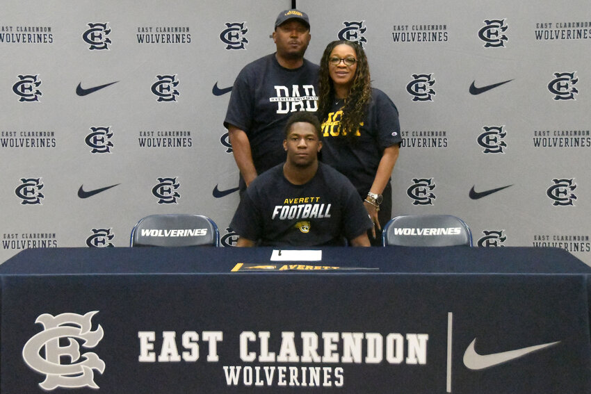 East Clarendon's Jaylon Barron, center, is joined by family as he signs to play football at Averett on Wednesday, May 20.