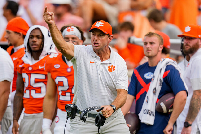 Clemson head coach Dabo Swinney, center, and the Tigers are projected to finish fourth in the ACC.