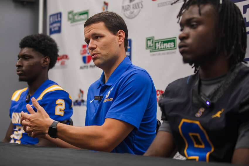 Sumter High head coach Drew Marlowe, center, speaks at The Sumter Item Football Media Day, presented by Hines Furniture, on Saturday. He's joined by quarterback Frank Richardson, left, and linebacker Rayshaun Dickey.