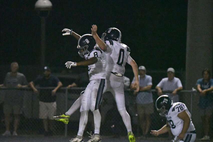 East Clarendon's Picasso Brown (8) and Cade Mooneyham (0) celebrate Brown's 66-yard touchdown run against Scott's Branch on Saturday.