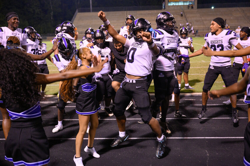 Crestwood's Calvin Wofford (0) and the Knights celebrate with their cheerleaders after beating Manning on Monday.