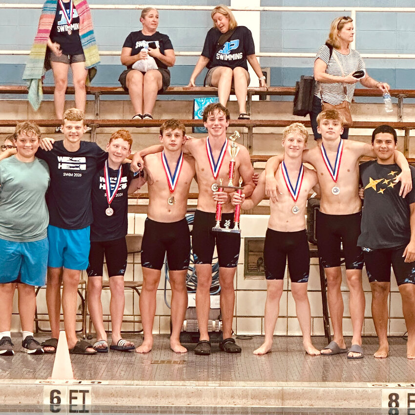 The Wilson Hall boys swim team celebrates after winning the Griffin Invitational on Saturday.