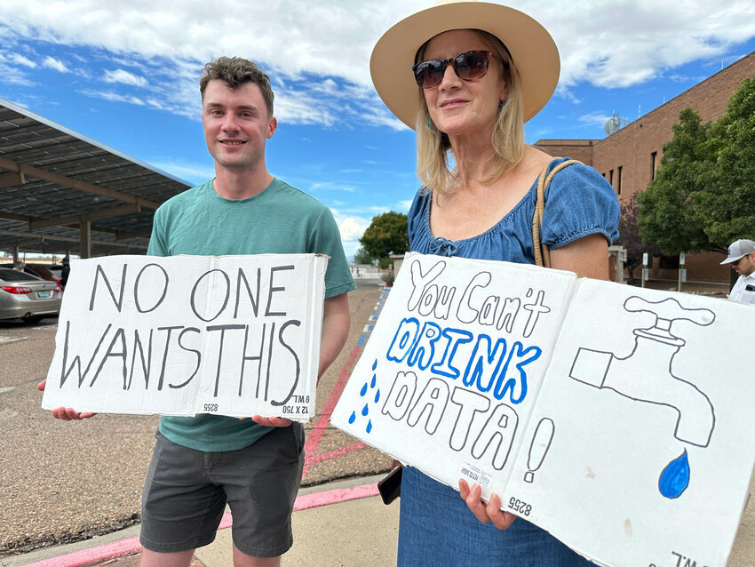 Jacob Weinreich and his mother Sharon Metcalf protest the Project Jupiter data center during a demonstration in Santa Fe, N.M., Friday, Aug. 21, 2026.