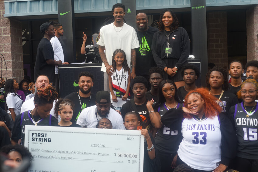Former Crestwood star Ja Morant, back center, poses with the basketball teams from his alma mater after donating $50,000 to the program in partnership with Nike and Hibbett Sports during the pregame tailgate at Crestwood on Friday.