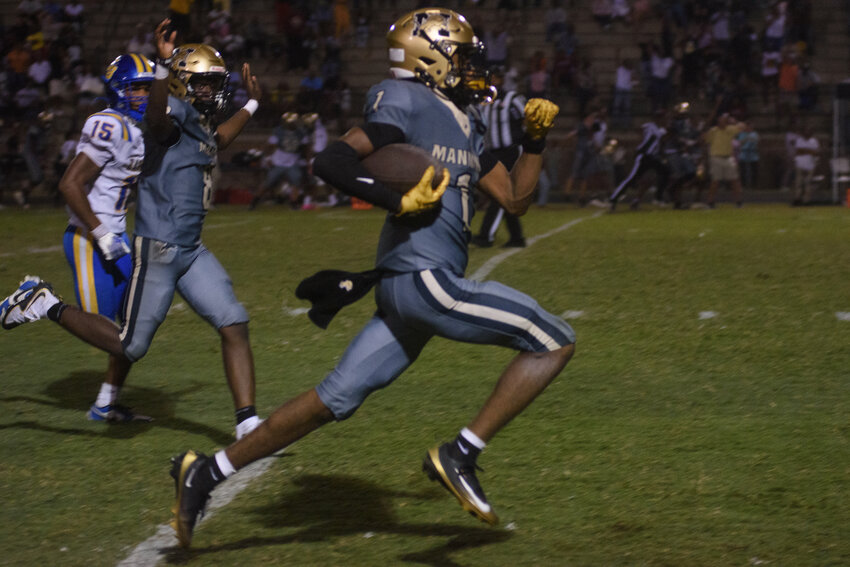 Manning's CJ Robinson carries the ball against Scott's Branch on Friday.