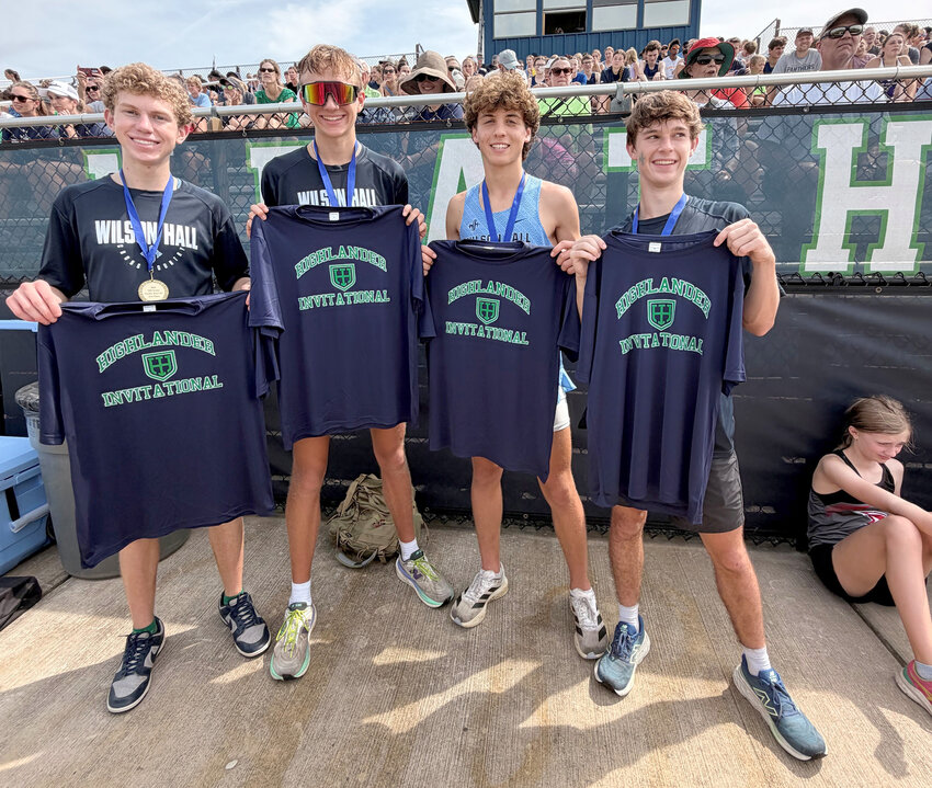 The Wilson Hall boys cross country team poses after winning the Highlander Invitational on Saturday.