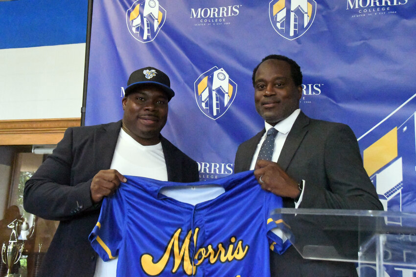 Incoming Morris College head baseball coach Kentaus Carter, left, receives a jersey and hat from Hornets athletic director Fredrick Summers during an introductory press conference on Wednesday.