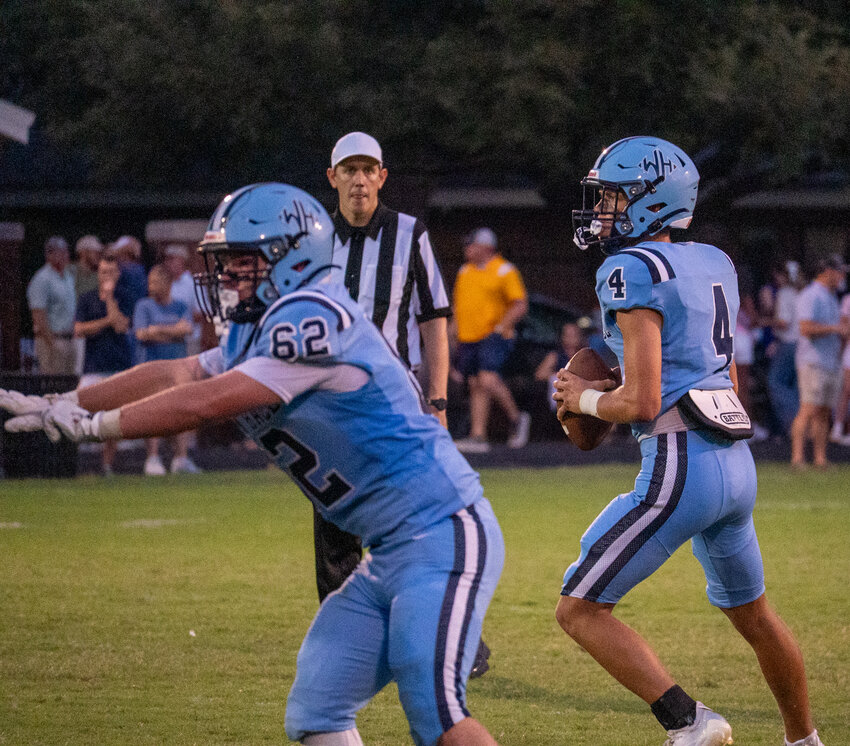 Wilson Hall's Nolan Gooch (4), seen passing against Hilton Head Christian on Aug. 28, passed for two touchdowns and ran for a third in the Barons' win over Williamsburg Academy on Friday.