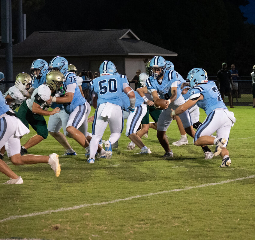 Wilson Hall's Nolan Gooch (4) hands off to Cameron Wilsey (7) against Thomas Sumter on Friday.