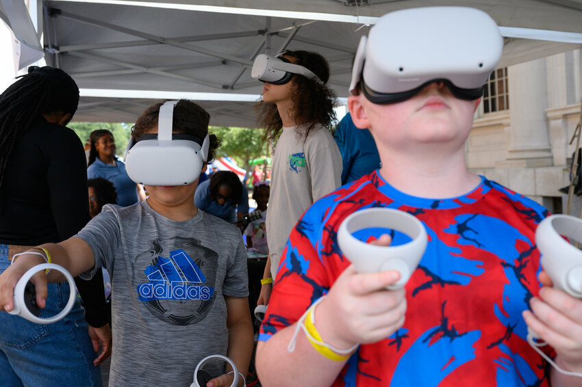 Kids try out virtual reality headsets during the 2025 eSTEAM festival in downtown Sumter. This year's event for families is Saturday, Oct. 3, and includes about 90 participating exhibitors.