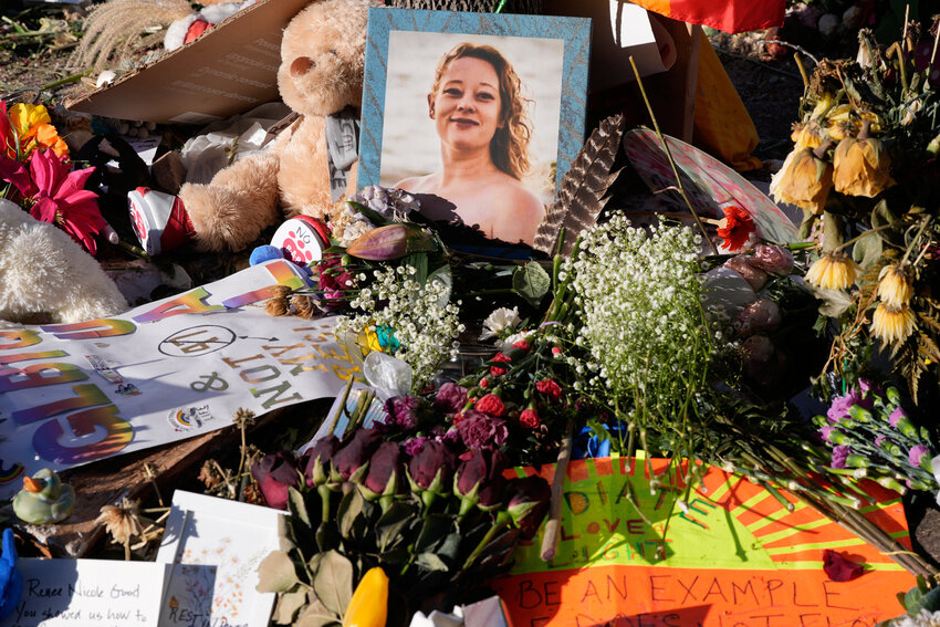 Flowers and photos are left at a memorial site for Renee Good on Saturday, Jan. 31, 2026, in Minneapolis.