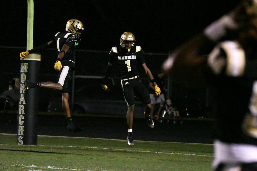 Manning's CJ Robinson (1) celebrates after returning a kick for a touchdown against East Clarendon on Friday.