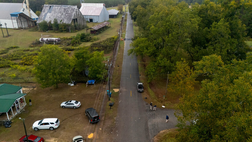 Authorities, below to the right, investigate the scene of a mass shooting where at least two people died and 35 were injured when struck by bullets Sunday morning, according to the Georgia Bureau of Investigation, Sunday, Oct. 4, 2026, in Vienna, Georgia.