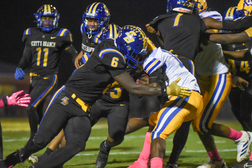 Scott's Branch linebacker Nyren Bowman (6) makes a tackle against Denmark-Olar on Friday.
