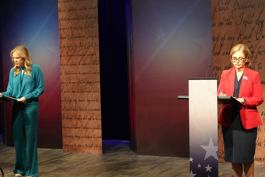 Dr. Annie Andrews, Democratic nominee for Senate in South Carolina, left, and Sen. Darline Graham, R-S.C., write notes ahead of a debate Sunday, Oct. 11, 2026, in Columbia, S.C.