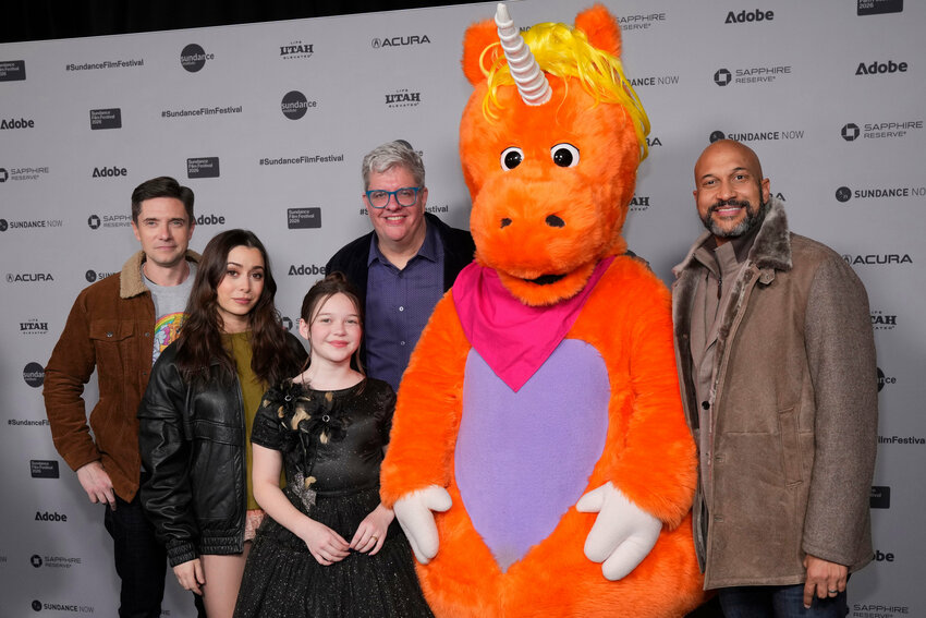 Topher Grace, from left, Cristin Milioti, Delaney Quinn, Casper Kelly and Keegan-Michael Key pose with the character Buddy at the premiere of "Buddy" during the Sundance Film Festival on Thursday, Jan. 22, 2026, at the Library Center Theatre in Park City, Utah.