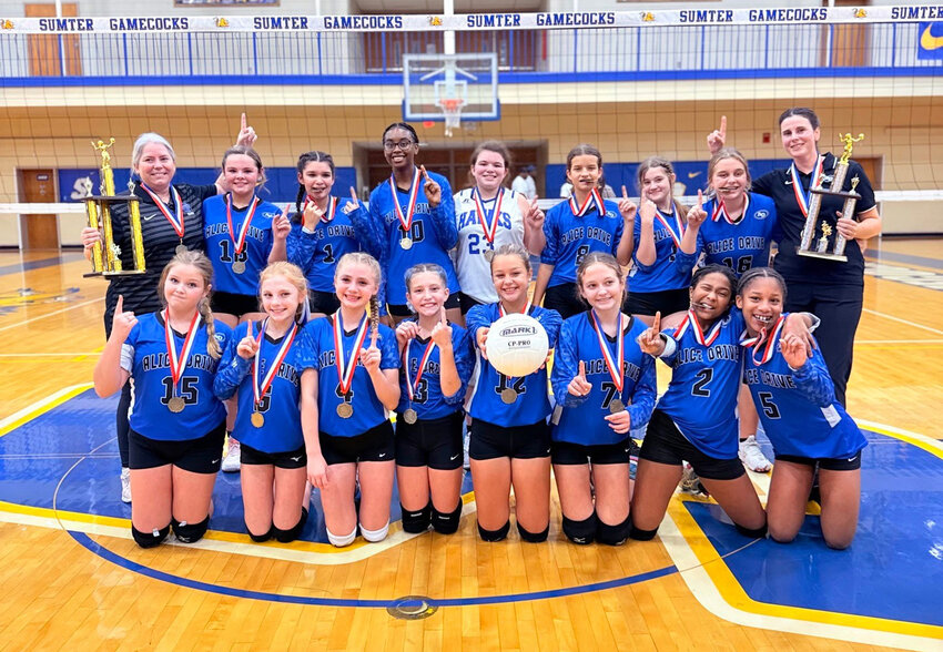 The Alice Drive Middle School volleyball team celebrates its district title on Saturday at Sumter High.