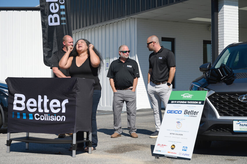 Greenville-based veteran Aimee Capuchina receives a car as a gift from several state partners at Better Collision on Broad Street on Oct. 13 in Sumter.