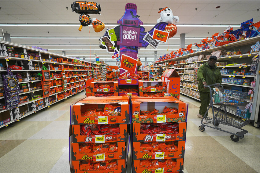A shopper walks by a Halloween candy display at a Giant grocery store on Thursday, Oct. 22, in Dundalk, Maryland.