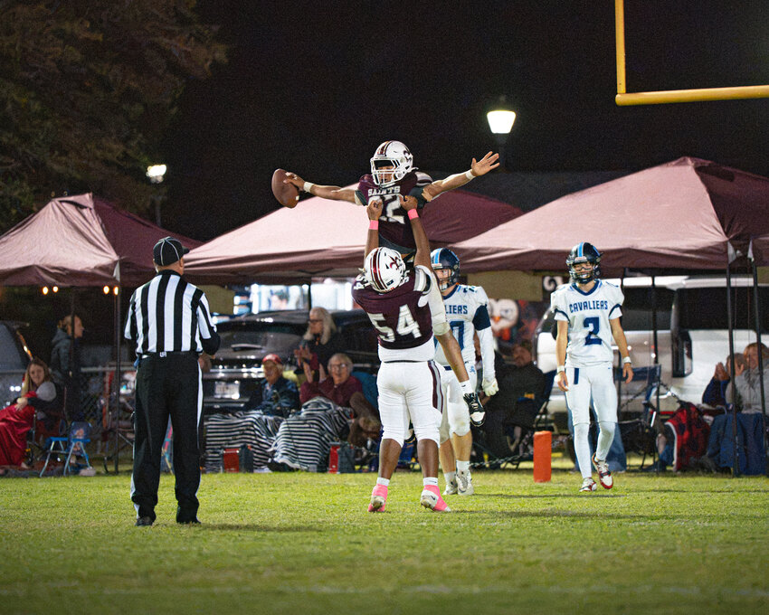Clarendon Hall's Andrew Pritcher (22) and Davem Patel celebrate a touchdown against Lee Academy on Friday.