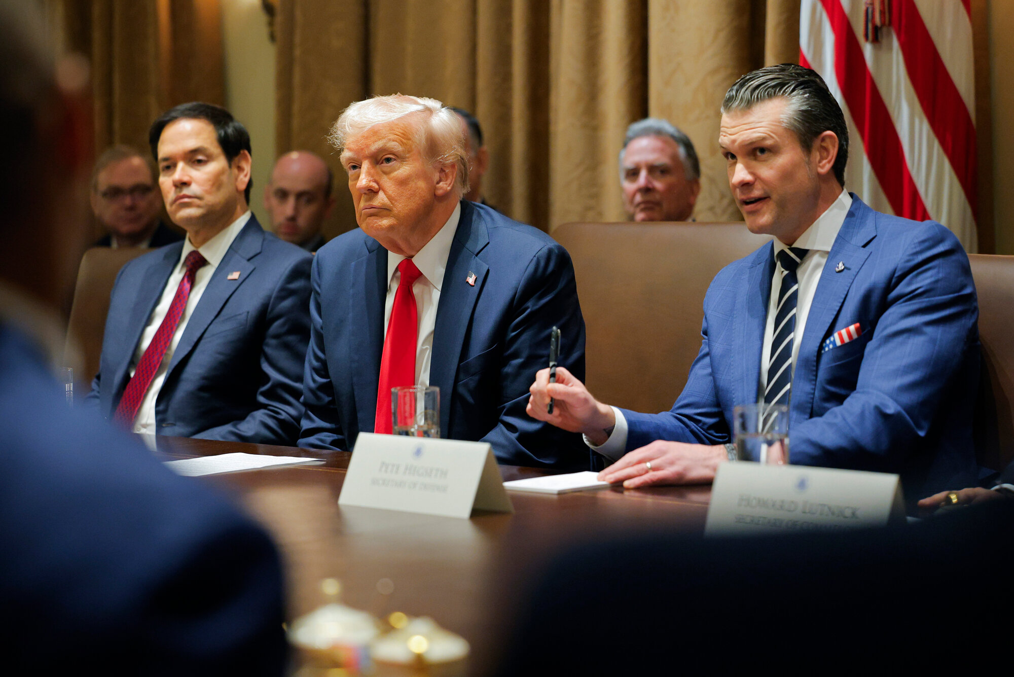 President Donald Trump listens during a Cabinet meeting at the White House in Washington, Tuesday, Feb. 26, 2025, as Secretary of State Marco Rubio and Defense Secretary Pete Hegseth listen.