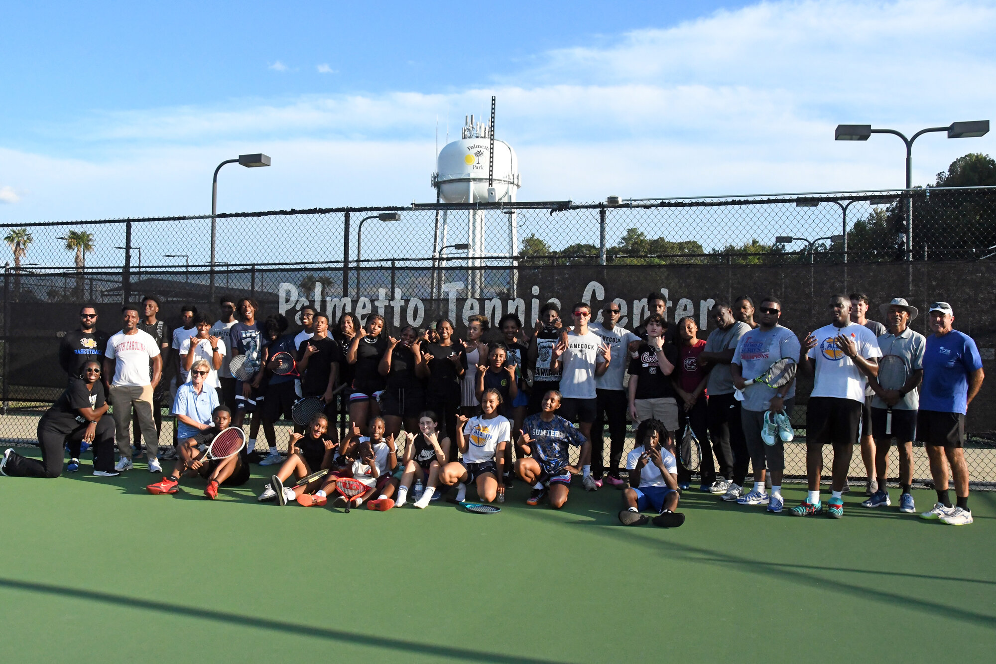 The Sumter High boys and girls basketball teams gather with the team at the Palmetto Tennis Center after an afternoon of learning tennis.